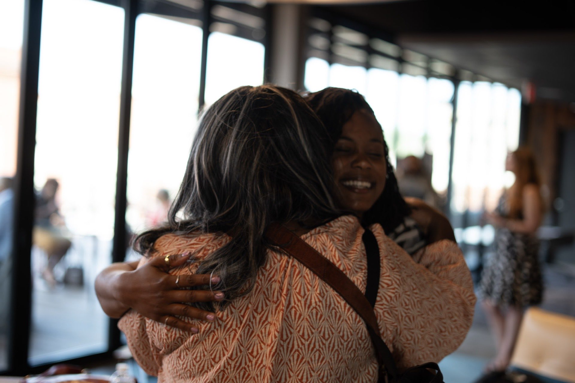 Two Richmond founders sharing a warm embrace at a community event