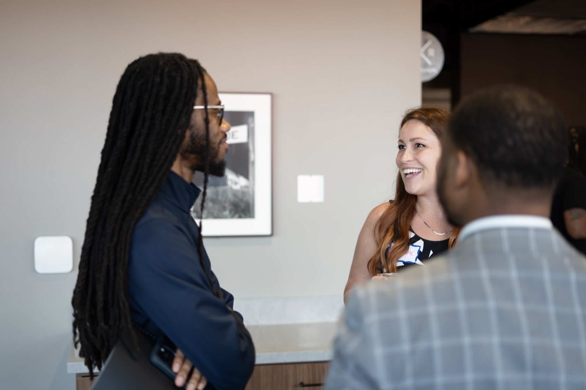 Two founders in animated conversation at a Richmond networking event
